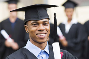 young man in a cap and gown smiling